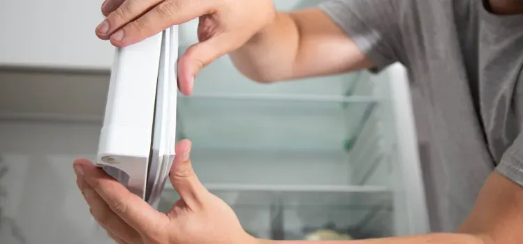 close-up-of-mans-hands-checking-refrigerator-door-seal